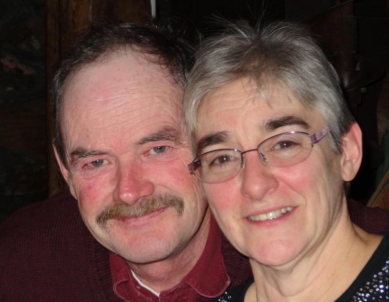Smiling couple posing together indoors.