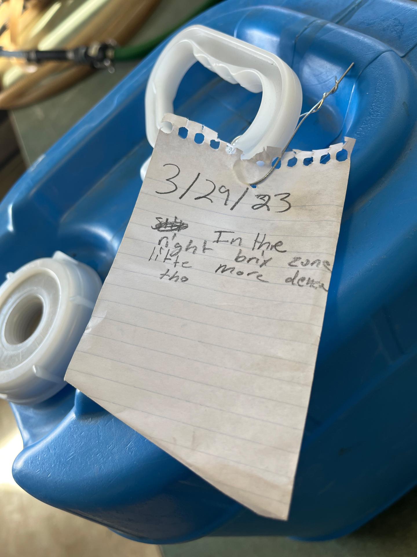 Note attached to blue plastic container.