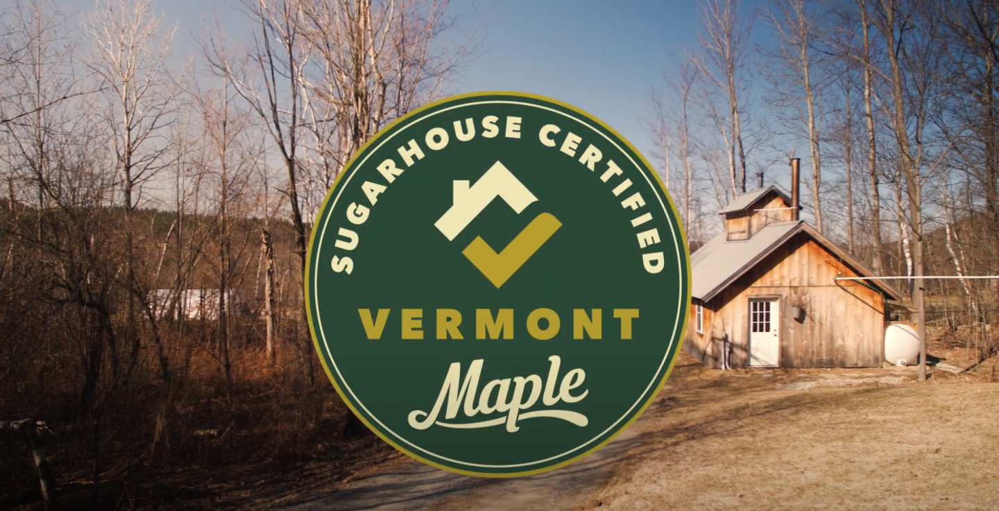 Vermont sugarhouse in winter, certified maple logo prominent.