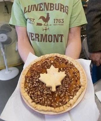 Person in a Lunenberg t-shirt holding an entry for the pie contest