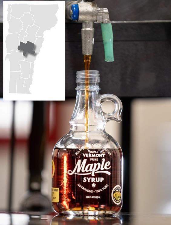 Maple syrup pouring into a glass bottle; inset map of Vermont.
