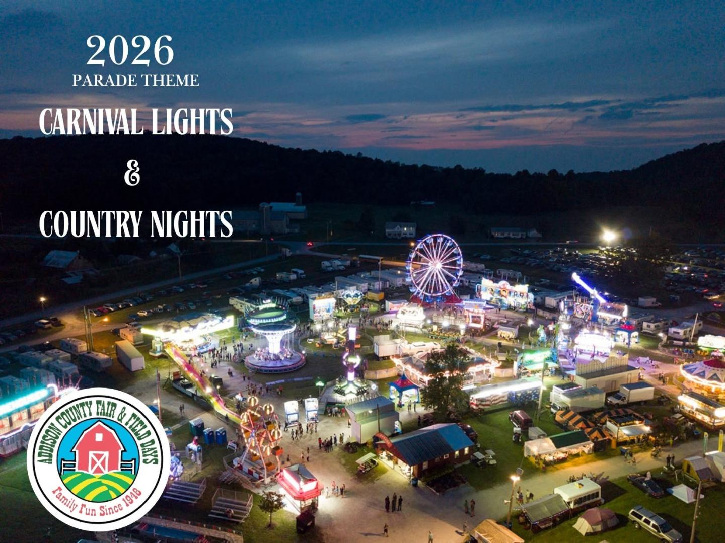 Night aerial view of a lit-up carnival with a Ferris wheel.